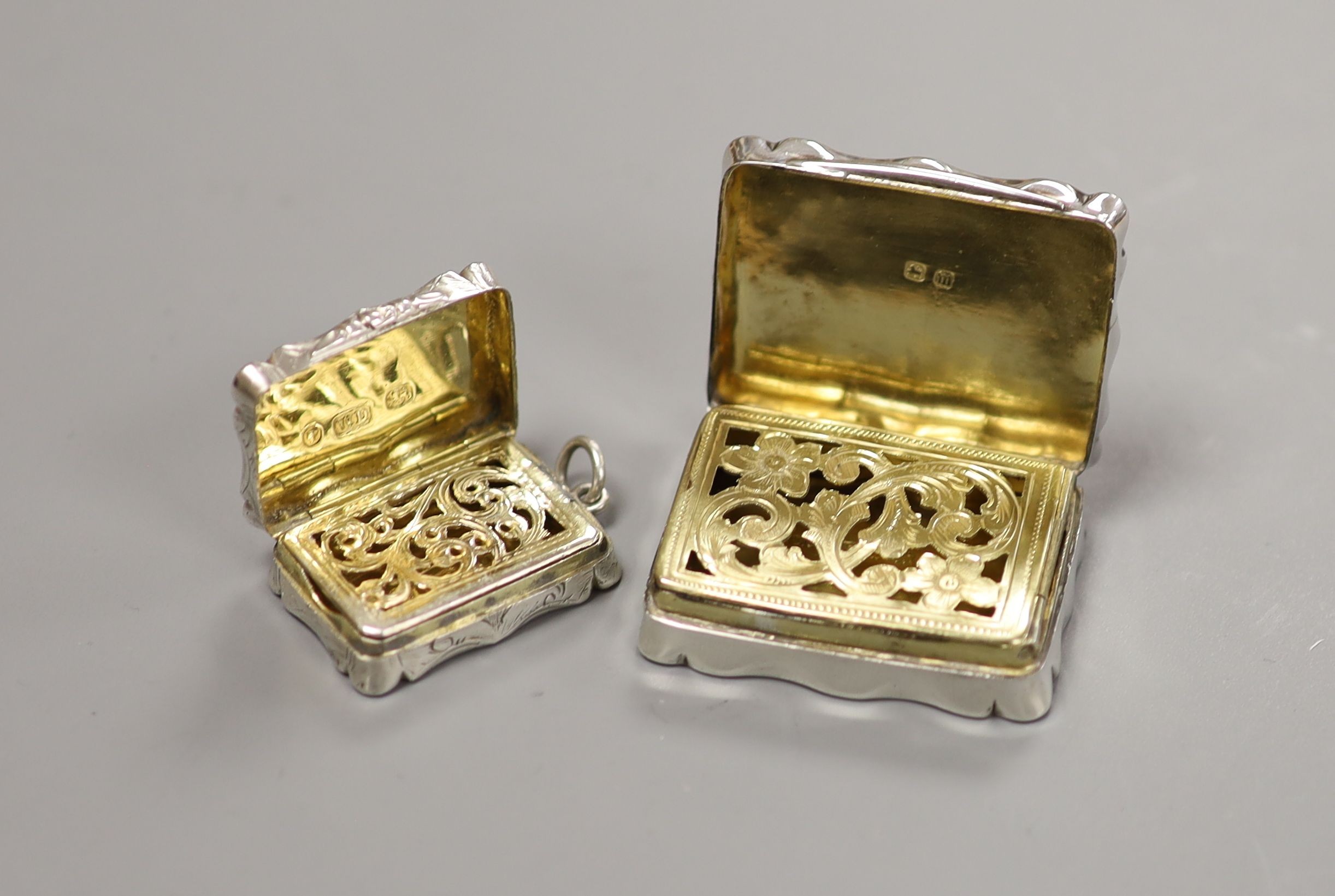 Two Victorian silver shaped rectangular vinaigrettes, Thomas Dones, Birmingham, 1855, 23mm and Colen Hewer Cheshire, Birmingham, 1895.